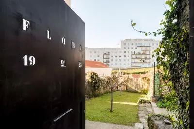 a black wall with numbers on it next to a building at Casa Flora in Porto