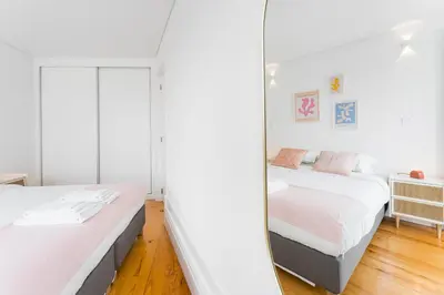 a bedroom with two beds and a mirror at Sunshine Luxury House Urban Retreat Downtown Porto in Porto