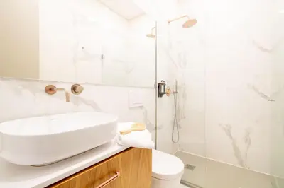 a white bathroom with a sink and a shower at Mouzinho da Silveira 215 by LovelyStay in Porto