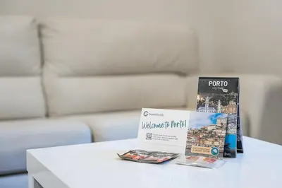 a table with two brochures and a book on it at GuestReady - Enigma Apartments in Porto