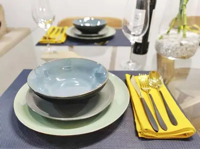 a table with a blue bowl and plates and silverware at Two Bedroom Terrace Sanctuary in the Center in Porto