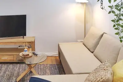a living room with a couch and a tv at Two Bedroom Terrace Sanctuary in the Center in Porto