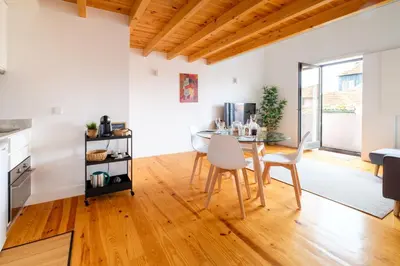 a kitchen and dining room with a table and chairs at PortoDise Loft by RDC in Porto