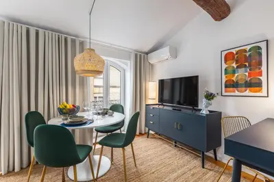 a living room with a table and chairs and a television at OPO Vale Formoso I in Porto