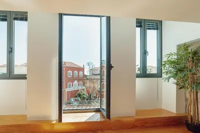 a room with glass doors with a view of a building at Modern & Stylish Apartments by Vacationy in Porto
