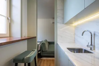 a kitchen with white counters and a sink at ORM Portas Santa Catarina Apartments in Porto