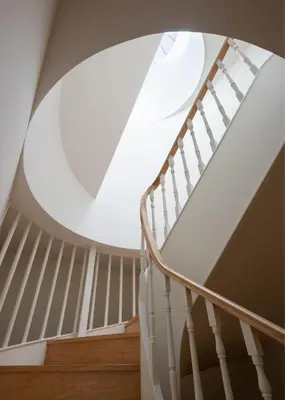 a spiral staircase with a large round window at ORM Portas Santa Catarina Apartments in Porto