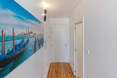 a hallway with a large painting on the wall at Lovely Bonfim in Porto