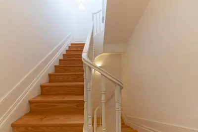 a staircase with white railings and wood floors at Lovely Bonfim in Porto