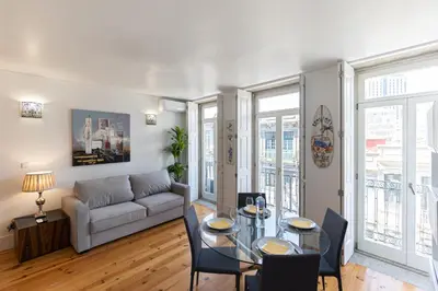 a living room with a table and a couch at Lovely Bonfim in Porto