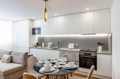 a kitchen and living room with a table and chairs at Pestana Apartments - In city center, Modern, New and Cozy in Porto