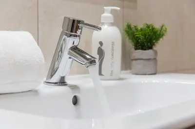 a bathroom sink with a faucet and a bottle of soap at GuestReady - Miragaia Stone Studios & Apartments in Porto