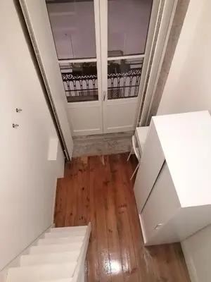 a staircase in a house with white walls and wooden floors at Rustic Silent Ensuites - Shared Kitchen - Self check in in Porto