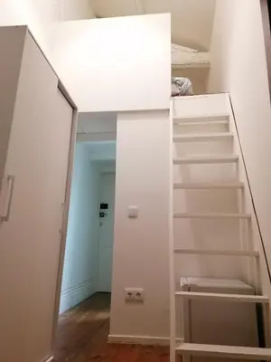 a staircase in a room with white walls and white shelves at Rustic Silent Ensuites - Shared Kitchen - Self check in in Porto