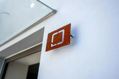 a metal sign on the side of a building at Ilha Douro Duplex in Porto