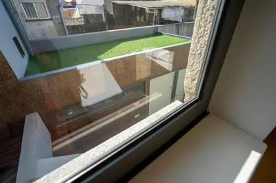 a window with a view of a yard at Ilha Douro Duplex in Porto