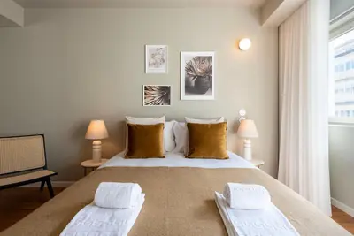 a bedroom with a large bed with two pillows at Ceuta 70 by LovelyStay in Porto