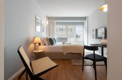 a bedroom with a bed and a table and chairs at Ceuta 70 by LovelyStay in Porto