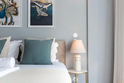 a bedroom with a white bed with a lamp and pictures at Ceuta 70 by LovelyStay in Porto