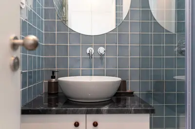a bathroom with a white sink and a mirror at Ceuta 70 by LovelyStay in Porto