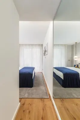 a bedroom with two beds and a mirror at Design Flat in Porto Downtown II in Porto