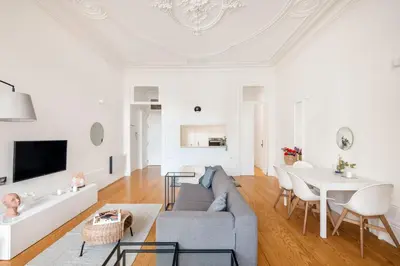 a living room with a couch and a table at MARKES · Lovely 1-bedroom home w/ sunny backyard in Porto