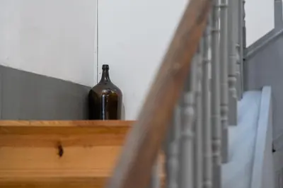 a bottle of wine sitting on a stairwell next to a stair case at Panorama Apartments Porto Clerigos in Porto