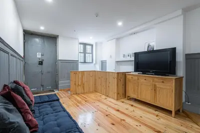 a living room with a flat screen tv and a couch at Panorama Apartments Porto Clerigos in Porto