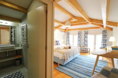 a bedroom with a bed and a bathroom at Porto Unique Cosy Duplex in Porto