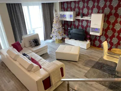 a living room with a white couch and a christmas tree at We are tourist in Vila Nova de Gaia