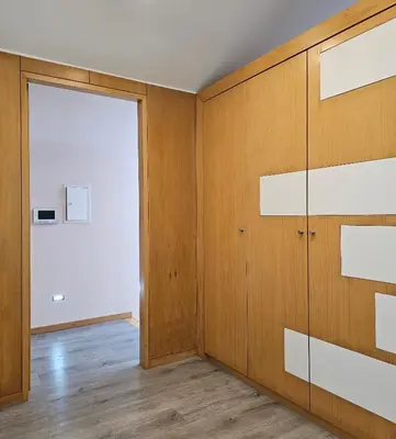 an empty room with a door and wooden walls at We are tourist in Vila Nova de Gaia