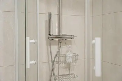 a shower with a shower head in a bathroom at GuestReady - Miragaia Stone Studios & Apartments in Porto