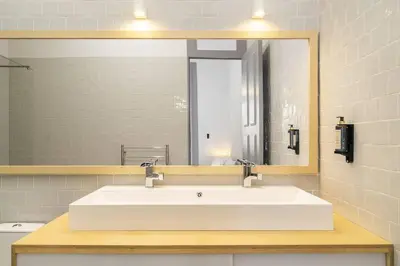 a bathroom with a shower and a toilet and a sink at Stylish Downtown Apartment in Porto