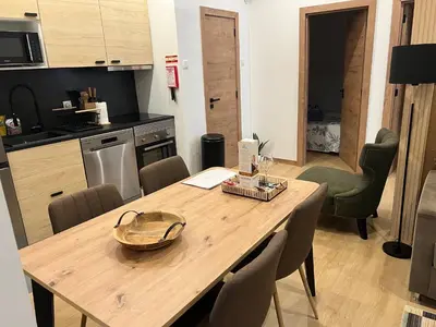 a kitchen with a wooden table and chairs in a room at Francisca City House in Vila Nova de Gaia