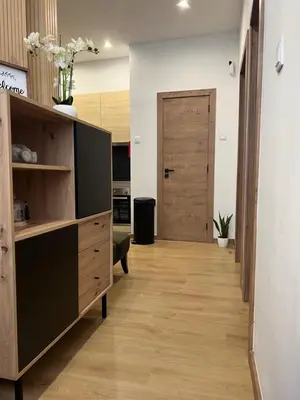 a hallway with a wooden cabinet and a door at Francisca City House in Vila Nova de Gaia