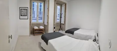 a bedroom with two beds and a window at Neo Porto Family & Friends in Porto