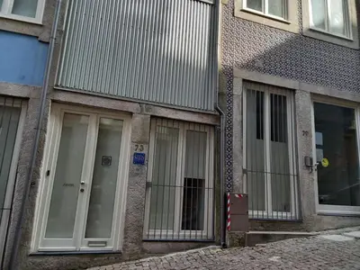a building with glass doors on the side of it at Neo Porto Family & Friends in Porto