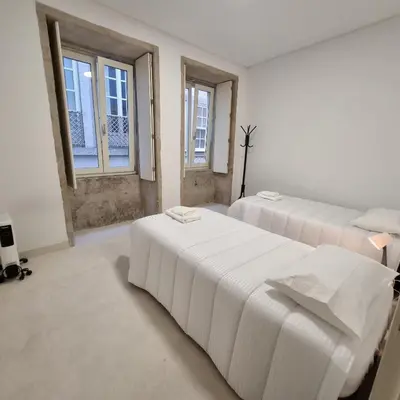 two beds in a room with two windows at Neo Porto Family & Friends in Porto