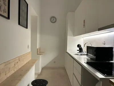 a white kitchen with a sink and a microwave at Neo Porto Family & Friends in Porto