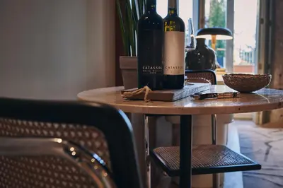 a table with two bottles of wine on it at Prim&Proper in Porto