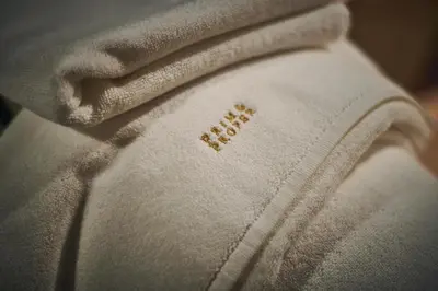 a close up of a white shirt with the word rebel on it at Prim&Proper in Porto