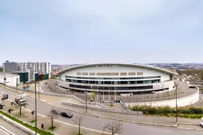 a large building with a road in front of it at Dragão - Indigo Antas Park in Porto