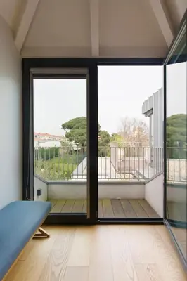a room with two large sliding doors and a balcony at Boutique Rentals-Primrose Terrace&Garage in Porto
