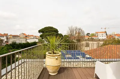 a potted plant sitting on top of a balcony at Boutique Rentals-Primrose Terrace&Garage in Porto
