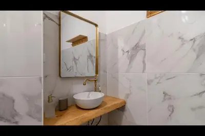 a white bathroom with a sink and a mirror at Campinho 1T - Stylish 1BR by LovelyStay in Porto