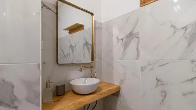 a white bathroom with a sink and a mirror at Campinho 1T - Stylish 1BR by LovelyStay in Porto