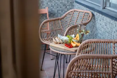 a table with a plate of food and glasses of wine at Campinho 1T - Stylish 1BR by LovelyStay in Porto