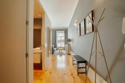a hallway with a table and a chair in a room at Downtown Excellence Apartment by Vacationy in Porto