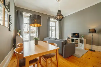 a living room with a table and a couch at Downtown Excellence Apartment by Vacationy in Porto