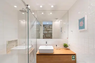 a white bathroom with a sink and a shower at Fontainhas Elite Apartments in Porto